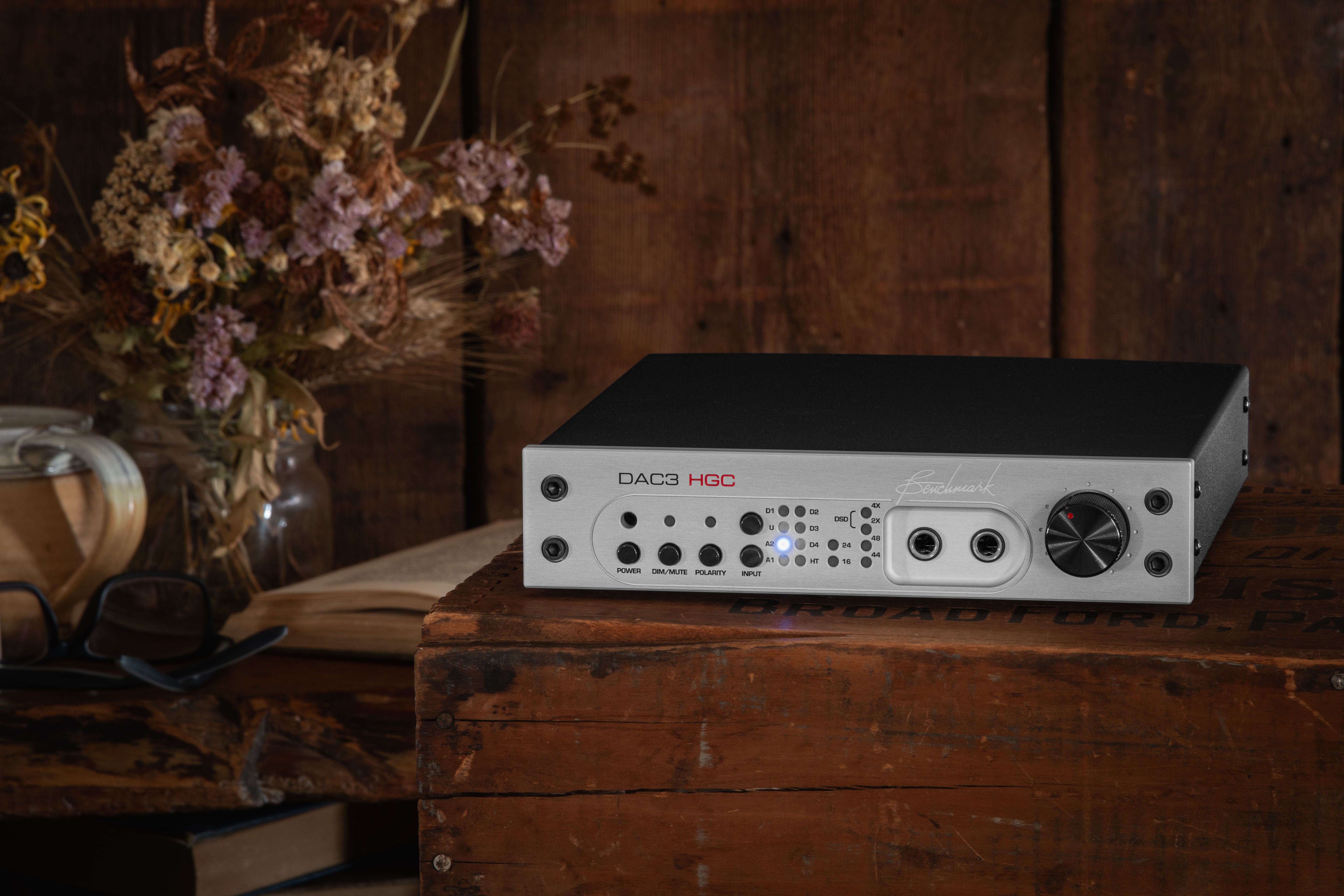 Benchmark DAC3 HGC with a silver face plate on a rustic wooden box